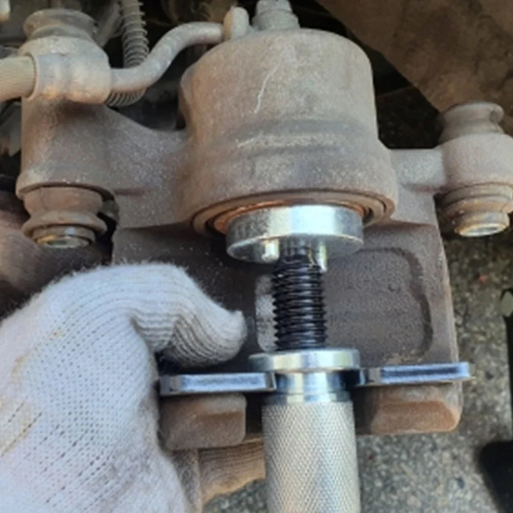 Brake caliper piston rewind tool installed during pad replacement