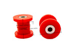 Large and small red poly control arm bushings with measurement lines across each one | Wrench Haus