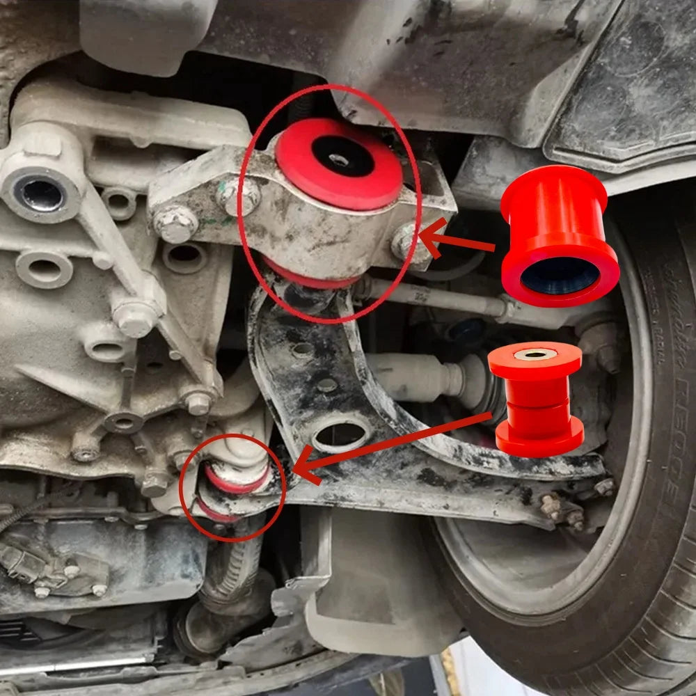 Red polyurethane bushings with arrows to their mounting points on a VW Golf front control arm | Wrench Haus
