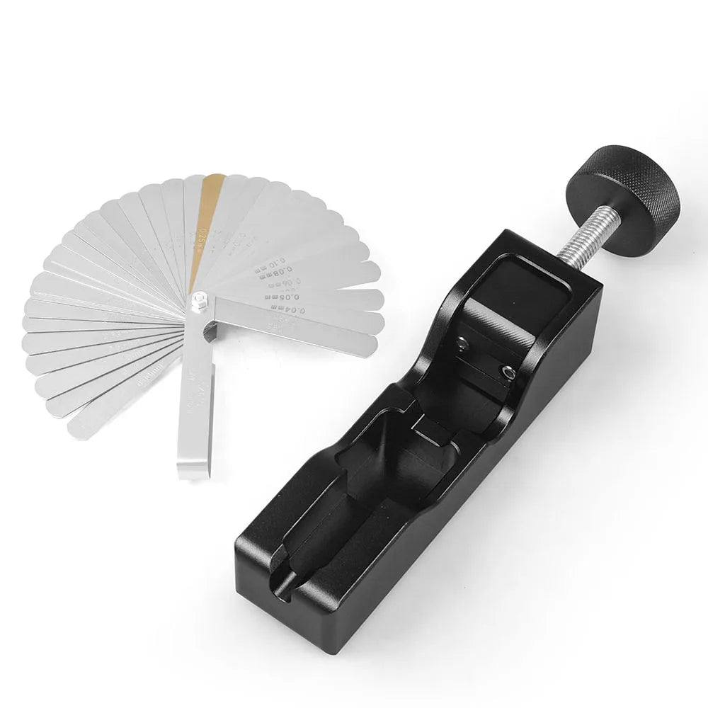 Black billet aluminum spark plug gap tool with the feeler gauge fanned out beside it | Wrench Haus