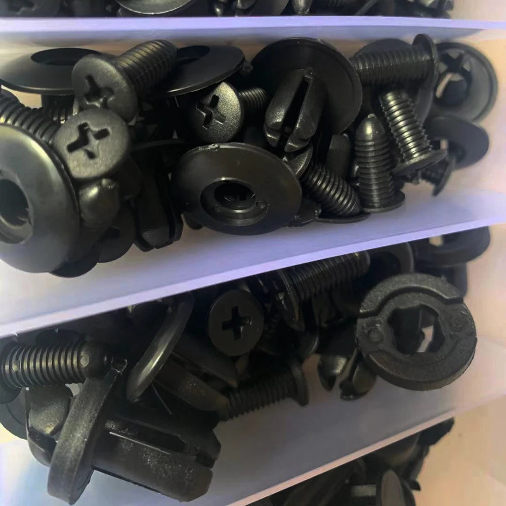 Close-up of black push retainer clips with screw heads inside the case compartments | Wrench Haus