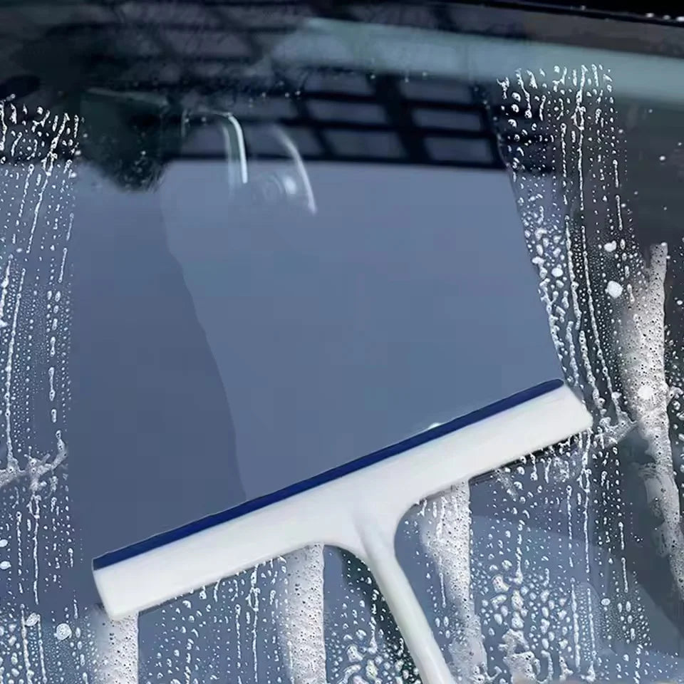 Squeegee blade clearing water from a windshield | Wrench Haus