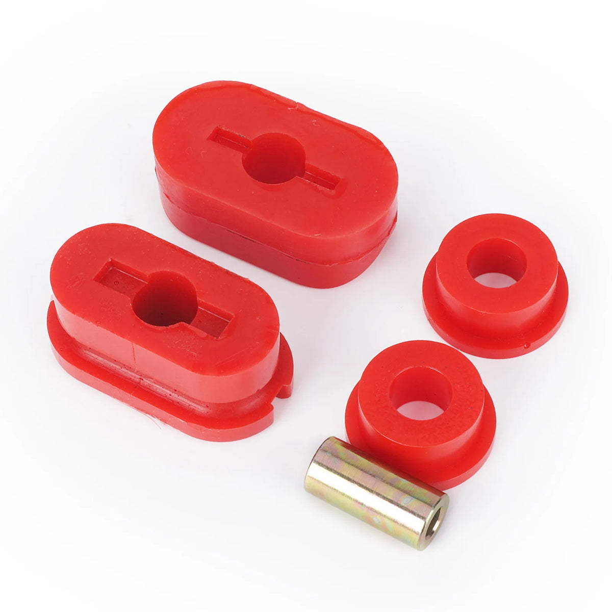 Full set of red polyurethane dog bone mount inserts and the steel center sleeve on white | Wrench Haus