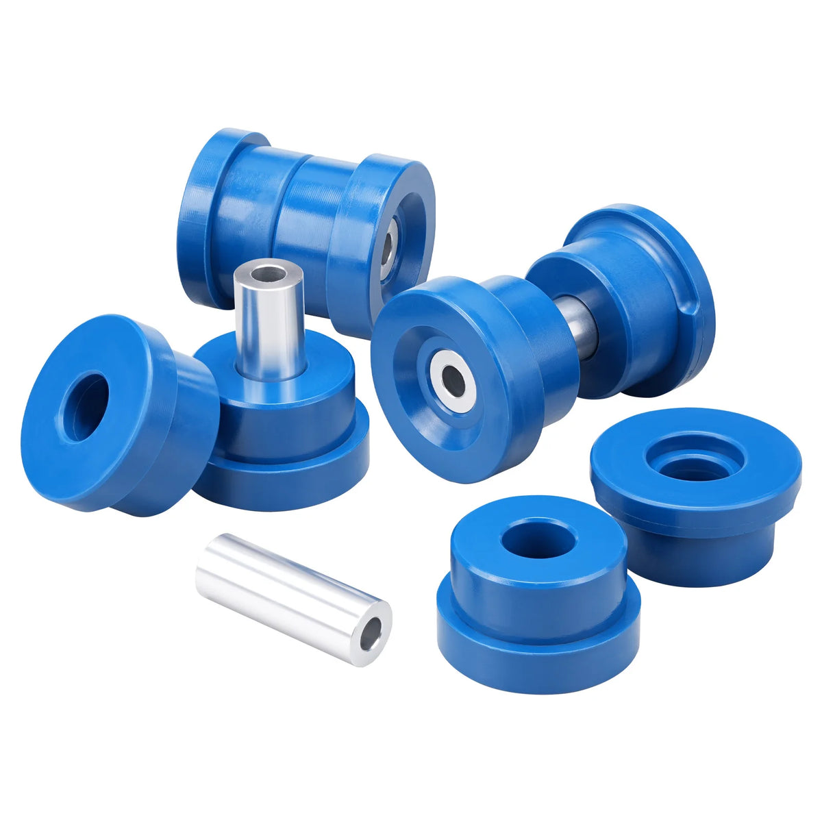 Complete blue polyurethane rear subframe bushing kit laid out with steel inner sleeves | Wrench Haus