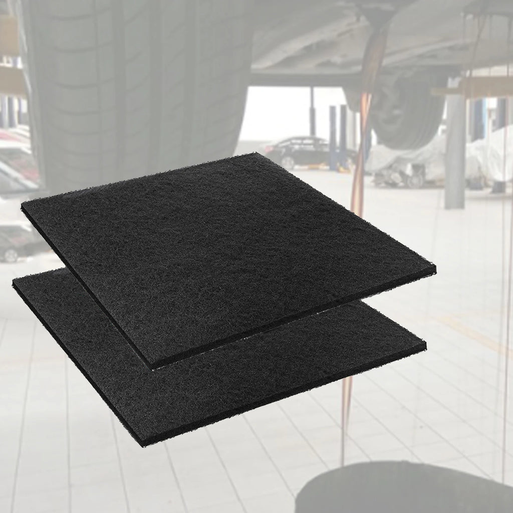 Oil Drain Splash Pad - Black rubber square pads stacked in workshop environment | Wrench Haus