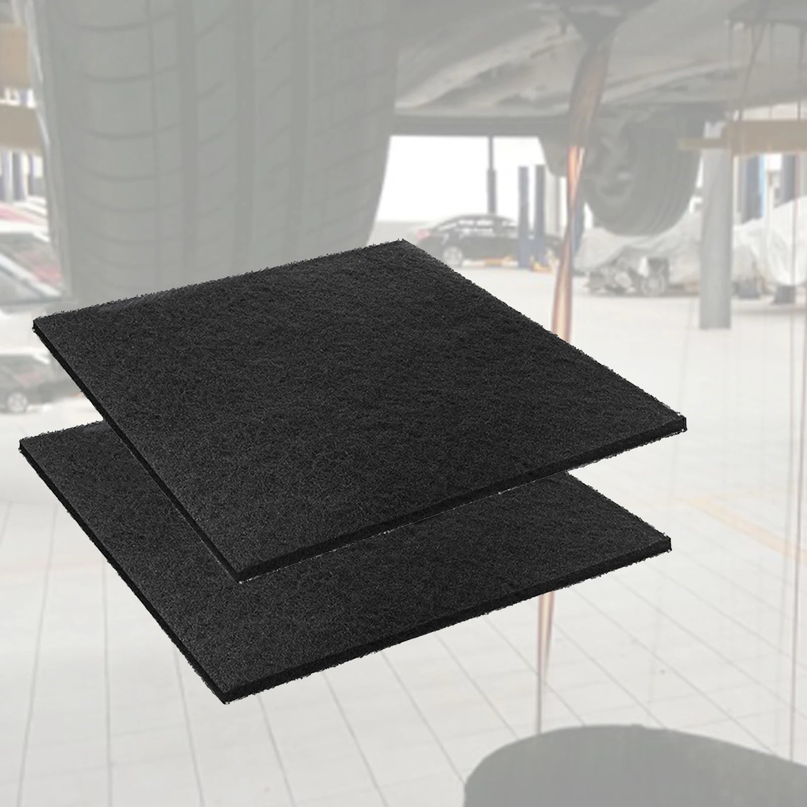 Oil Drain Splash Pad - Black rubber square pads stacked in workshop environment | Wrench Haus