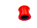 Large red polyurethane control arm bushing on a black background | Wrench Haus