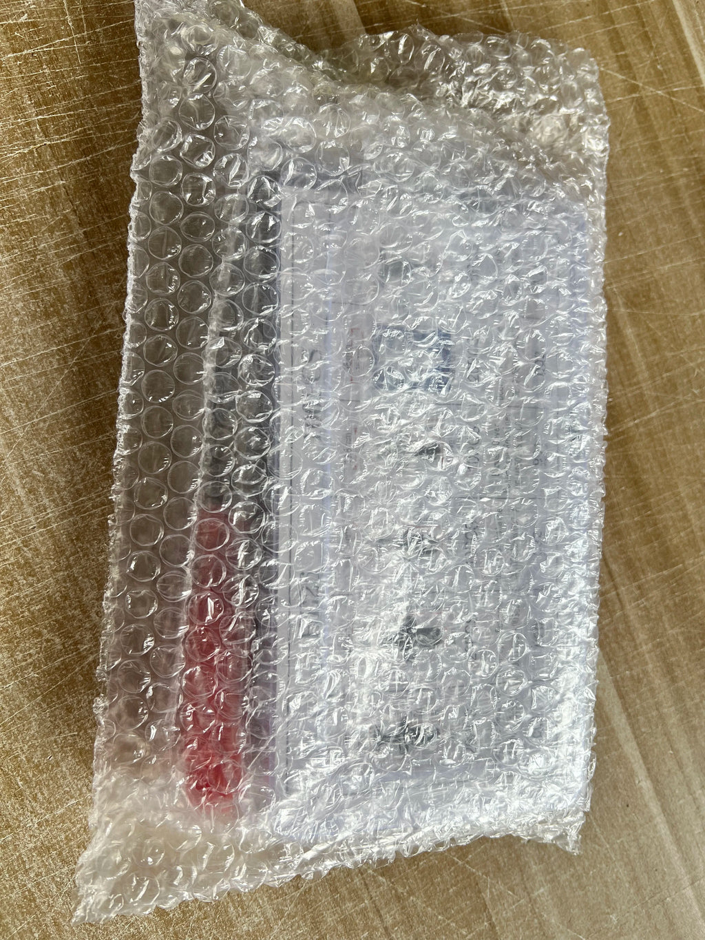 Push retainer clip kit as shipped, sealed in bubble wrap with the red pry tool inside | Wrench Haus