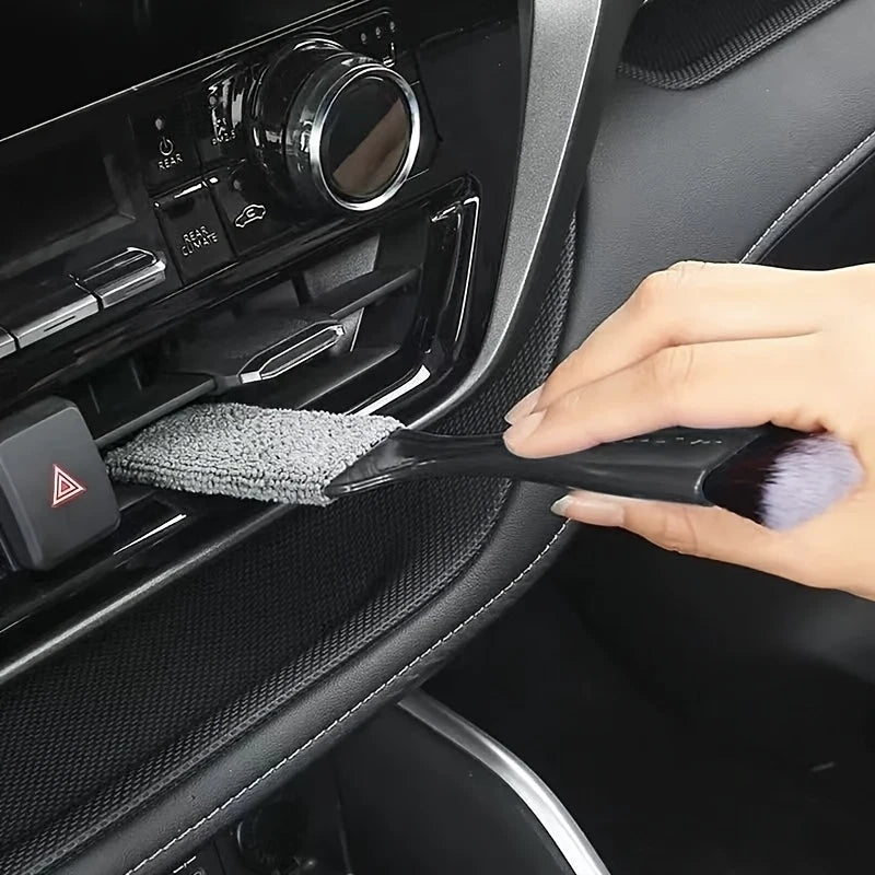Soft-bristled detailing brush cleaning a car dashboard | Wrench Haus