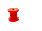 Small red polyurethane control arm bushing with metal sleeve on a black background | Wrench Haus