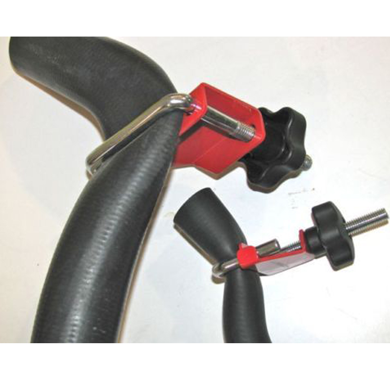 4-Piece Fluid Line Hose Clamp Set - Large and small clamps gripping black rubber hoses | Wrench Haus